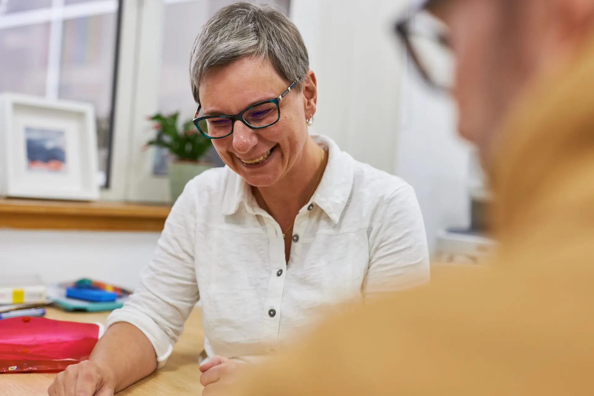 Tutor smiling with adult learner